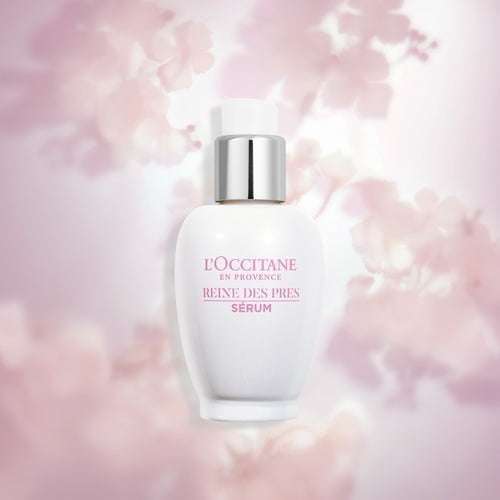 Koncentrirani serum za razsvetlitev polti Reine des Prés L'Occitane na roza ozadju