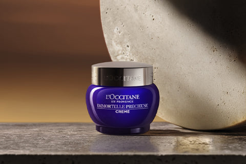 L'Occitane Žlahtna krema za obraz na kamnitem ozadju