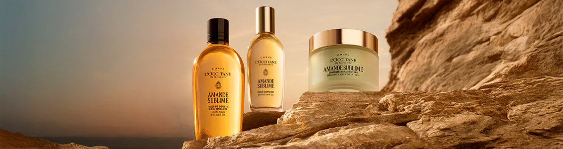 L’Occitane kolekcija Amande Sublime – priljubljena kolekcija Mandelj je zdaj na voljo v prenovljenih embalažah – elegantne stekleničke v pastelnih barvah z zlatimi in črnimi pokrovčki 