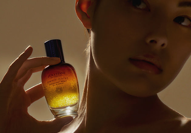 Ženska drži ob vatu Booster za nočno nego obraza Immortelle Reset - L'Occitane