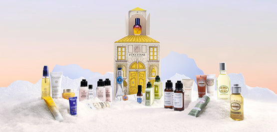 L'Occitane Adventni koledar 2025 z razstavljenimi izdelki na zasneženi podlagi 